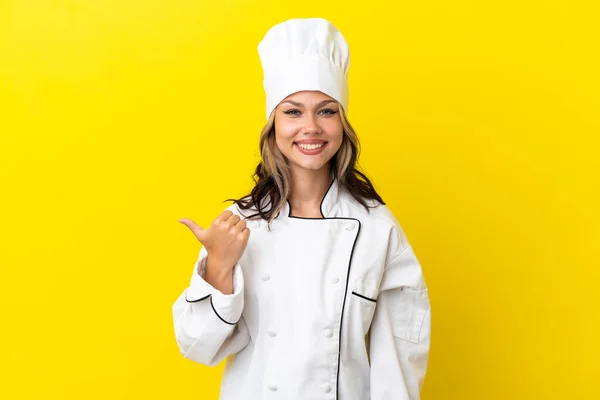 Young Russian Chef Girl Isolated Yellow Background Pointing Side Present — стоковое фото
