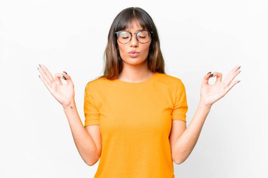 Young caucasian woman over isolated white background in zen pose