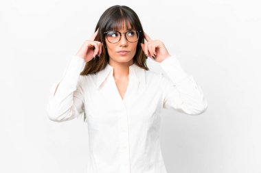 Young caucasian woman over isolated white background having doubts and thinking