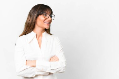 Young caucasian woman over isolated white background with arms crossed and happy