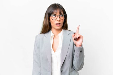 Young caucasian woman over isolated white background thinking an idea pointing the finger up