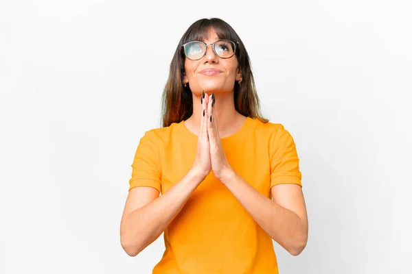 stock image Young caucasian woman over isolated white background keeps palm together. Person asks for something