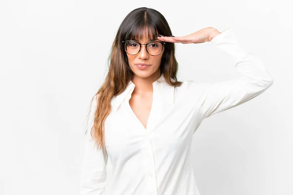 stock image Young caucasian woman over isolated white background saluting with hand with happy expression