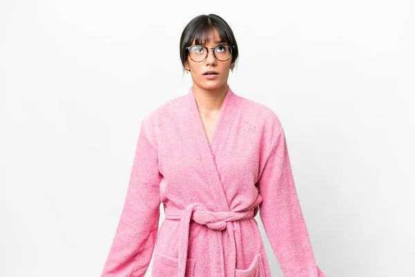 stock image Young woman in a bathrobe over isolated white background looking up and with surprised expression