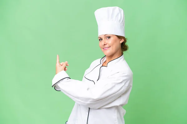 Mulher Chef Meia Idade Sobre Fundo Isolado Apontando Para Trás — Fotografia de Stock