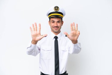 Airplane pilot over isolated white background counting nine with fingers