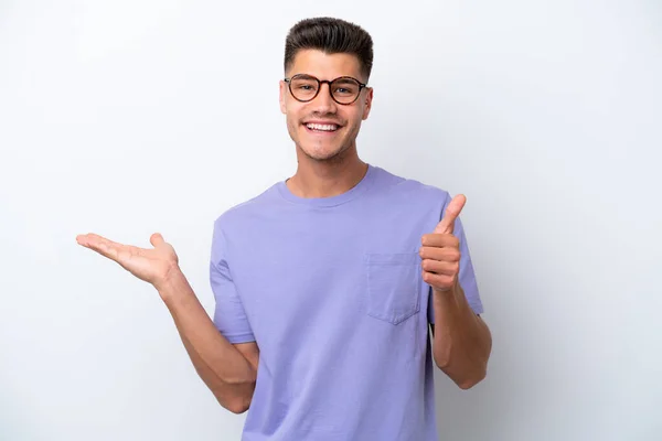 Young Caucasian Man Isolated White Background Holding Copyspace Imaginary Palm — Stockfoto