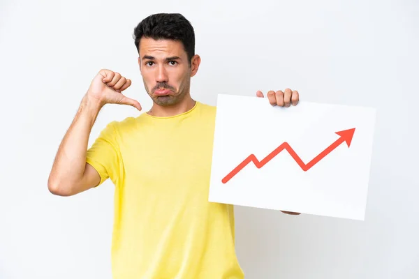 stock image Young handsome man over isolated white background holding a sign with a growing statistics arrow symbol with proud gesture
