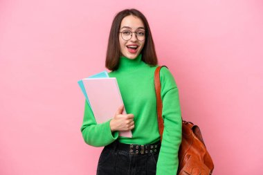 Young student Ukrainian woman isolated on pink background with surprise facial expression