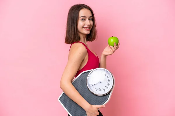 Young Ukrainian Woman Isolated Pink Background Weighing Machine Apple — Stock Fotó