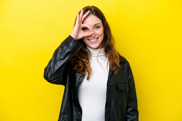 stock image Young caucasian woman isolated on yellow background showing ok sign with fingers