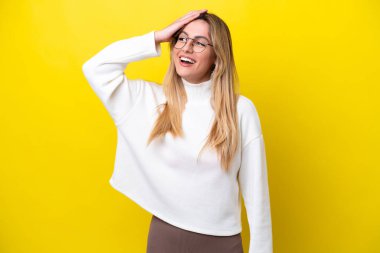 Young Uruguayan woman isolated on yellow background smiling a lot