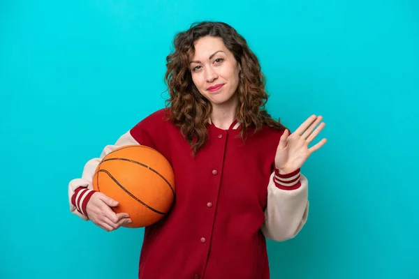 Young Caucasian Basketball Player Woman Isolated Blue Background Saluting Hand — Stock fotografie