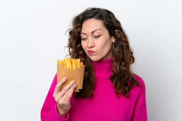 Young Caucasian Woman Catching French Fries Isolated White Background Sad — 스톡 사진