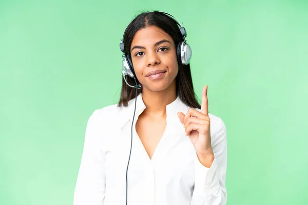 stock image Telemarketer African American woman working with a headset over isolated chroma key background pointing with the index finger a great idea