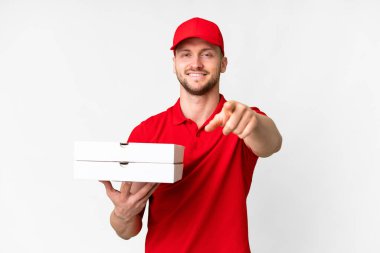 Pizza delivery man with work uniform picking up pizza boxes over isolated white background pointing front with happy expression