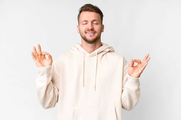 stock image Young handsome caucasian man over isolated white background in zen pose