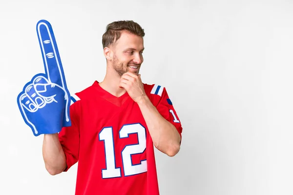 stock image Young caucasian sports fan man over isolated white background thinking an idea and looking side