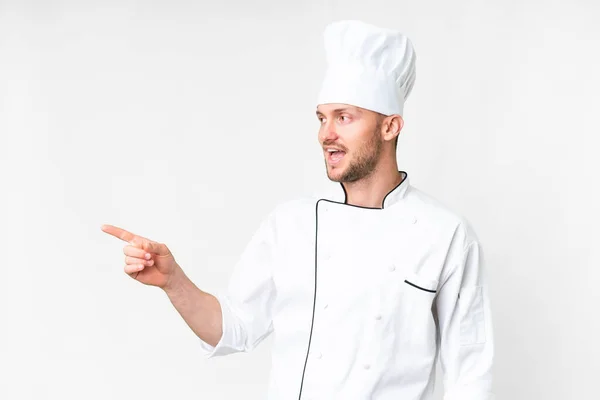 Young Caucasian Chef Isolated White Background Pointing Finger Side Presenting — Photo