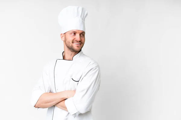 stock image Young caucasian chef over isolated white background with arms crossed and happy