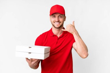 Pizza delivery man with work uniform picking up pizza boxes over isolated white background making phone gesture. Call me back sign