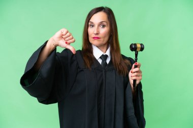 Judge caucasian woman  over isolated background showing thumb down with negative expression