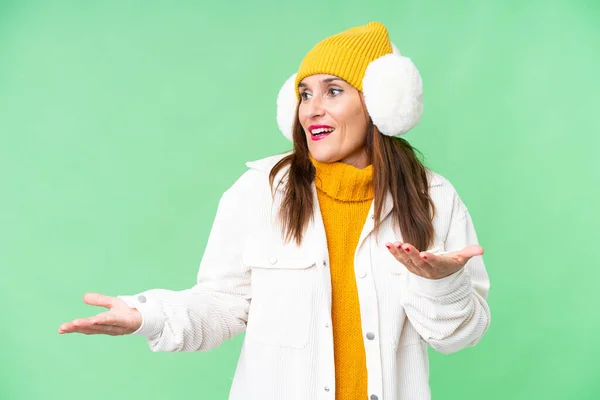 Middle Age Woman Wearing Winter Muffs Isolated Chroma Key Background — Zdjęcie stockowe
