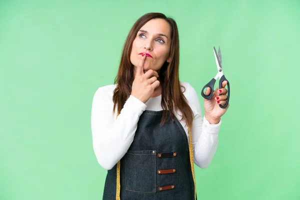 Seamstress Woman Isolated Chroma Key Background Having Doubts While Looking — Stock Photo, Image