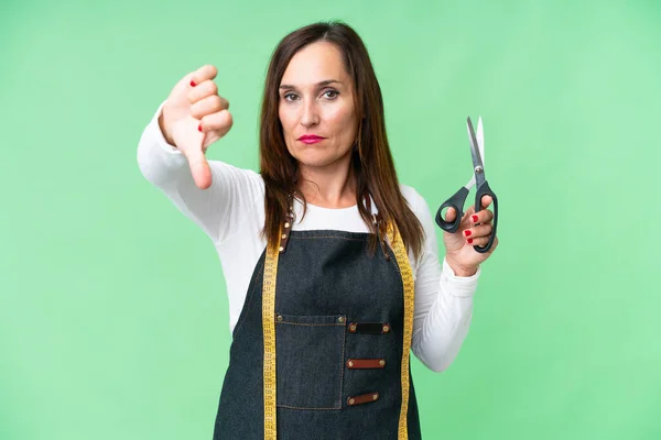 Seamstress Woman Isolated Chroma Key Background Showing Thumb Negative Expression — ストック写真