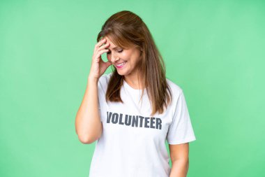 Middle age volunteer woman over isolated background laughing