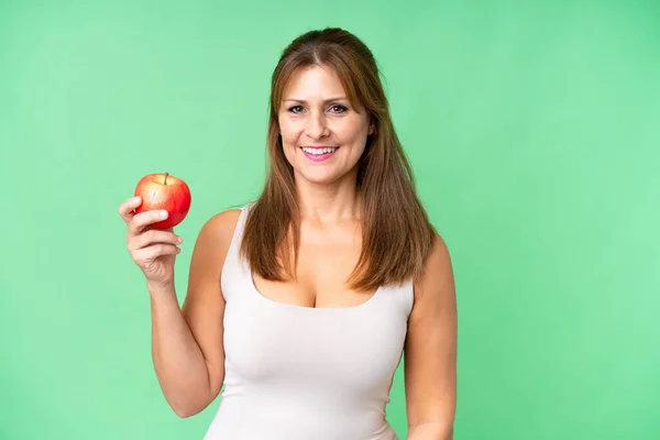 Frau Mittleren Alters Mit Einem Apfel Vor Isoliertem Hintergrund Lächelt — Stockfoto