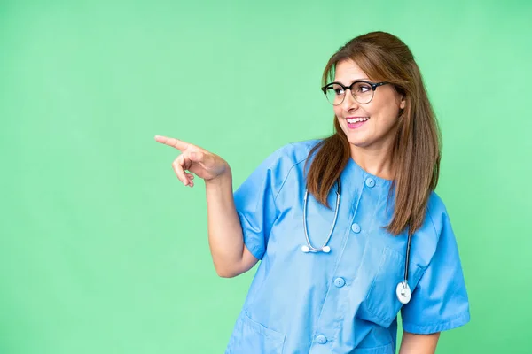Middle Age Nurse Woman Isolated Background Pointing Finger Side Presenting — Stock Photo, Image