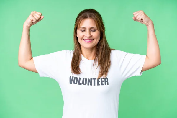 stock image Middle age volunteer woman over isolated background doing strong gesture