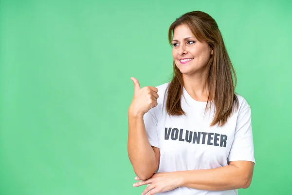 stock image Middle age volunteer woman over isolated background pointing to the side to present a product