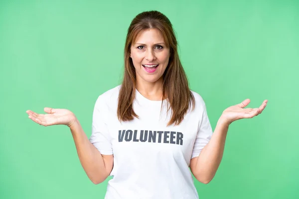 stock image Middle age volunteer woman over isolated background with shocked facial expression