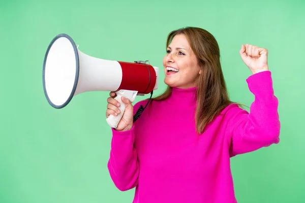 Middle Age Woman Isolated Background Shouting Megaphone Announce Something Lateral —  Fotos de Stock