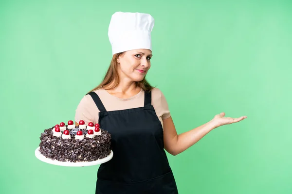 Middle Age Pastry Chef Woman Holding Big Cake Isolated Background — Stock fotografie