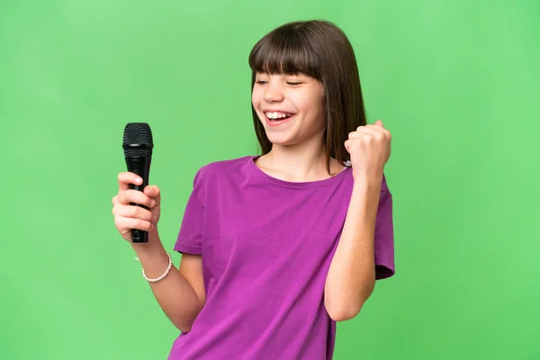 Little Singer Girl Picking Microphone Isolated Background Celebrating Victory — Stock Photo, Image
