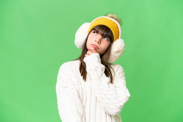 Little Caucasian Girl Wearing Winter Muffs Isolated Background Having Doubts —  Fotos de Stock