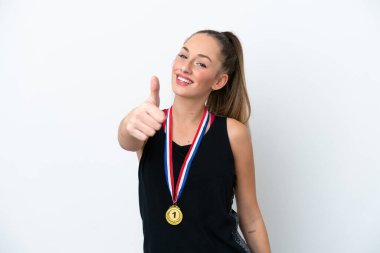 Young caucasian woman with medals isolated on white background with thumbs up because something good has happened