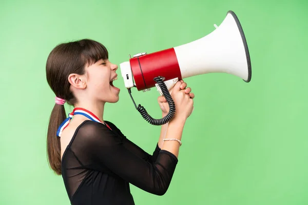 Little Caucasian Girl Medals Isolated Background Shouting Megaphone — Stock Photo, Image