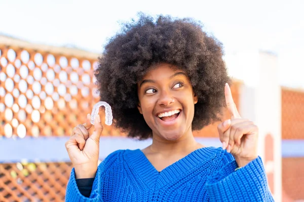African American Girl Holding Invisible Braces Outdoors Intending Realizes Solution — Stock Photo, Image