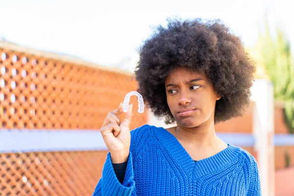 African American Girl Holding Invisible Braces Outdoors Sad Expression — Stock Photo, Image