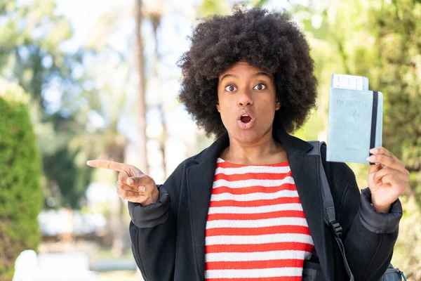 African American Girl Holding Passport Outdoors Surprised Pointing Side — Stock Photo, Image
