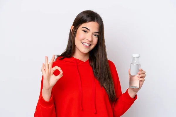 Young Brazilian woman with a bottle of water isolated on white background showing ok sign with fingers