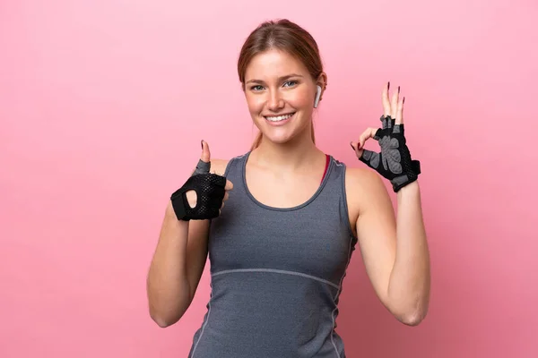 若いですスポーツCucasian女性隔離上のピンクの背景ショーOk Signと親指アップジェスチャー — ストック写真