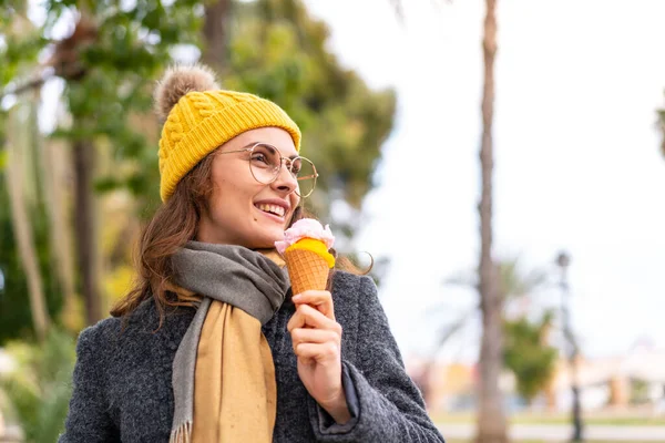 stock image Brunette woman with a cornet ice cream at outdoors