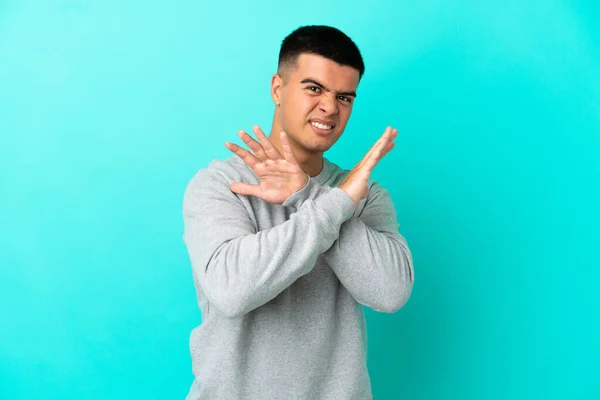 Jonge Knappe Man Geïsoleerde Blauwe Achtergrond Nerveus Strekken Handen Naar — Stockfoto