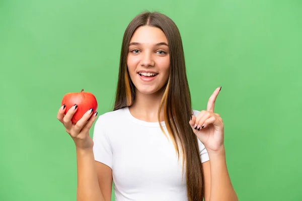 十几岁的白人女孩抱着一个苹果在与世隔绝的背景下提出了一个伟大的想法 — 图库照片