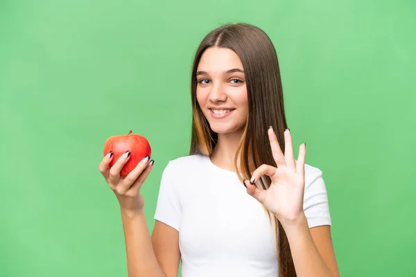 Teenager Kaukasischen Mädchen Hält Einen Apfel Über Isolierten Hintergrund Zeigt — Stockfoto